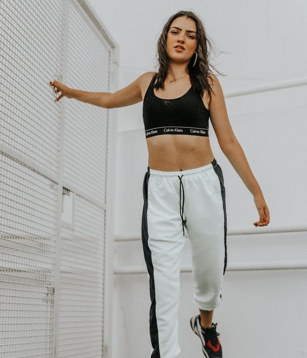 Woman in a dynamic and energetic pose, feeling full of vitality.